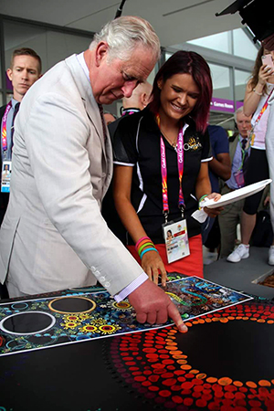 Chern'ee Sutton with Prince Charles finger painting Commonwealth Games 