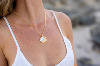 Woman wearing an Australian gold yin yang pendant necklace.